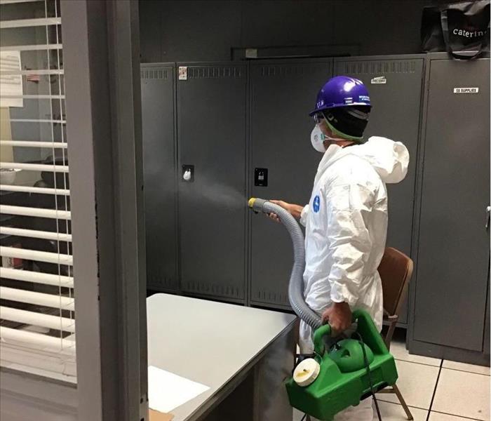SERVPRO crew member sprays commercial building as a part of their CSC Program