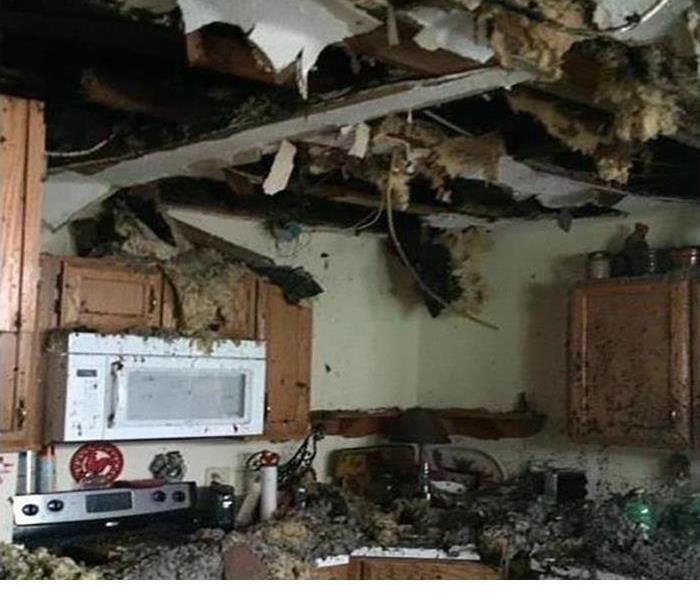 Fire damaged kitchen with soot and smoke throughout the kitchen and cabinets