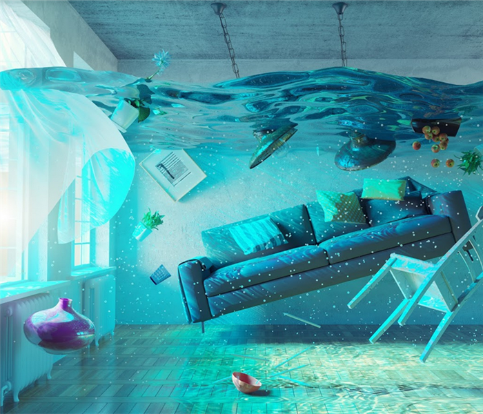flooded living room with furniture and items floating in the water
