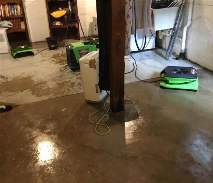 Flooding basement has SERVPRO equipment to help dry the structure and cement flooring