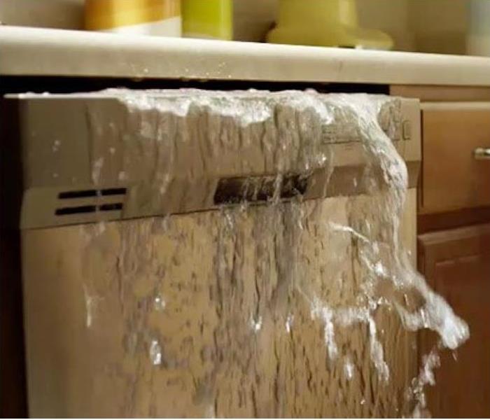 Dishwasher with water flowing out of the top